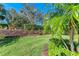 Landscaped backyard with lush greenery and palm trees at 5016 Savona Run, Bradenton, FL 34211