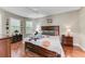 Spacious bedroom with wood flooring, large windows, and a ceiling fan at 5016 Savona Run, Bradenton, FL 34211
