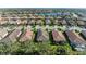 Community aerial view showcasing numerous homes and a lake at 5016 Savona Run, Bradenton, FL 34211