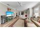 Open concept living room with hardwood floors, a large TV, and comfortable seating at 5016 Savona Run, Bradenton, FL 34211