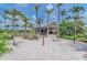 Sandy beach area with lounge chairs and tropical landscaping at 5016 Savona Run, Bradenton, FL 34211