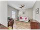 Bright office features wood floors, built-in shelving and a comfortable sofa at 5016 Savona Run, Bradenton, FL 34211