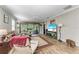 Spacious living room featuring hardwood floors, a ceiling fan, and access to the backyard at 5016 Savona Run, Bradenton, FL 34211