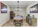 Dining room featuring a rustic table, unique sideboard, and statement lighting at 5016 Savona Run, Bradenton, FL 34211