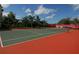 Green and red tennis court in community at 5122 Northridge Rd # 207, Sarasota, FL 34238