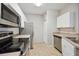 View of kitchen, stainless steel appliances and white cabinets at 5122 Northridge Rd # 207, Sarasota, FL 34238