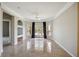 Bright living room with tile floors, built-in shelving, and sliding glass doors to balcony at 5122 Northridge Rd # 207, Sarasota, FL 34238