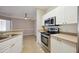 Kitchen with stainless steel appliances and white cabinets at 5122 Northridge Rd # 207, Sarasota, FL 34238