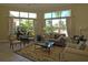 Elegant living room with large windows and pool view at 5122 Northridge Rd # 207, Sarasota, FL 34238