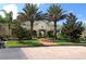 Community clubhouse with palm trees and landscaped grounds at 5122 Northridge Rd # 207, Sarasota, FL 34238