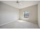 Bedroom with ceiling fan, neutral walls, and carpet flooring at 5122 Northridge Rd # 207, Sarasota, FL 34238