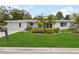 Ranch-style home with attractive landscaping and a well-maintained lawn at 2425 Clematis St, Sarasota, FL 34239