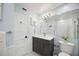 Modern bathroom with a dark vanity and white tile at 2425 Clematis St, Sarasota, FL 34239
