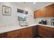Modern kitchen with wood cabinets, quartz countertops, and stainless steel appliances at 2425 Clematis St, Sarasota, FL 34239