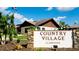 Country Village clubhouse exterior with landscaping and signage at 2911 74Th W St # 2276, Bradenton, FL 34209