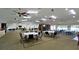 Spacious clubhouse interior with tables, chairs, and a fireplace at 2911 74Th W St # 2276, Bradenton, FL 34209