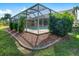 Screened-in pool with surrounding landscaping at 2837 Cabaret St, Port Charlotte, FL 33948