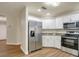 Updated kitchen boasting stainless steel appliances and white shaker cabinets at 2837 Cabaret St, Port Charlotte, FL 33948
