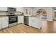 Modern kitchen with stainless steel appliances, white cabinets, and granite countertops at 2837 Cabaret St, Port Charlotte, FL 33948