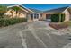 Home's front yard features mature landscaping and a driveway at 2837 Cabaret St, Port Charlotte, FL 33948