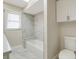 Updated bathroom features a bathtub, marble tile, and a window at 2837 Cabaret St, Port Charlotte, FL 33948