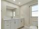 Bathroom with white vanity, quartz countertop and large mirror at 2837 Cabaret St, Port Charlotte, FL 33948