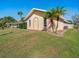 Home's side yard features landscaping and palm trees at 2837 Cabaret St, Port Charlotte, FL 33948