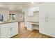 Open concept kitchen with white cabinets, granite countertops and built-in desk at 2837 Cabaret St, Port Charlotte, FL 33948