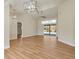 Bright living room with vaulted ceiling, hardwood floors, and sliding glass doors leading to the pool at 2837 Cabaret St, Port Charlotte, FL 33948