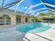 Kidney-shaped pool with a covered patio area at 2837 Cabaret St, Port Charlotte, FL 33948