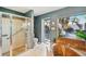 Bathroom featuring a standalone shower, garden tub, and exterior views at 218 Brandywine Circle, Englewood, FL 34223