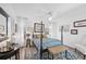 Light and airy bedroom with a four-poster bed, ceiling fan, and decorative rugs at 218 Brandywine Circle, Englewood, FL 34223