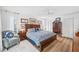 Traditional bedroom with a wood bed frame, hardwood floors, and bright natural light at 218 Brandywine Circle, Englewood, FL 34223