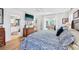 Bedroom view with an ensuite bath, TV, and sliding door access to an outdoor living space at 218 Brandywine Circle, Englewood, FL 34223
