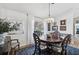 Bright dining room with elegant chandelier, beautiful wood table, and charming decor at 218 Brandywine Circle, Englewood, FL 34223