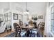 Cozy dining area with decorative chairs, a wood table, and an abundance of natural light at 218 Brandywine Circle, Englewood, FL 34223