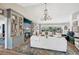 Bright living room with built-in shelving, fireplace, chandelier, and large sliding glass doors to the lanai at 218 Brandywine Circle, Englewood, FL 34223