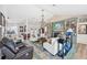 Open living area with vaulted ceilings, large windows, fireplace, and views of the outdoor living space at 218 Brandywine Circle, Englewood, FL 34223