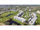 Aerial showing condo community near golf course and water at 3860 Ironwood Ln # 106G, Bradenton, FL 34209