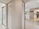 Hallway with mirrored closet and view of kitchen at 3860 Ironwood Ln # 106G, Bradenton, FL 34209