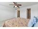 Bedroom with tiled floors, ceiling fan, and bathroom access at 3860 Ironwood Ln # 106G, Bradenton, FL 34209