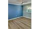 Bright bedroom featuring light walls and wood-look floors at 5769 Antietam Dr, Sarasota, FL 34231