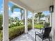 Inviting front porch with patio furniture and view of lush landscaping at 7996 Sandstar Way, Sarasota, FL 34240