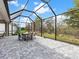 Covered patio with screened enclosure and view of backyard at 7996 Sandstar Way, Sarasota, FL 34240