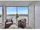 Relaxing screened balcony overlooking the water with comfortable seating at 9397 Midnight Pass Rd # 505, Sarasota, FL 34242