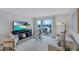 Living room with water views, comfortable seating and large TV at 9397 Midnight Pass Rd # 505, Sarasota, FL 34242