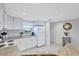 Modern white kitchen with granite countertops and stainless steel appliances at 9397 Midnight Pass Rd # 505, Sarasota, FL 34242