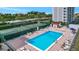 Resort-style pool with tennis courts and water views at 9397 Midnight Pass Rd # 505, Sarasota, FL 34242