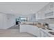 Modern white kitchen with granite countertops and stainless steel appliances at 9397 Midnight Pass Rd # 505, Sarasota, FL 34242