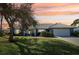 Ranch-style home with a two-car garage and landscaped yard at 218 Brandywine Circle, Englewood, FL 34223